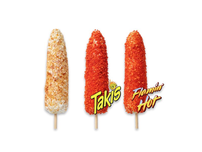 Three different flavors of Mexican street corn on a stick (elote): one classic with Cotija cheese, one covered in Takis chili powder, and one covered in Flamin' Hot Cheeto dust.