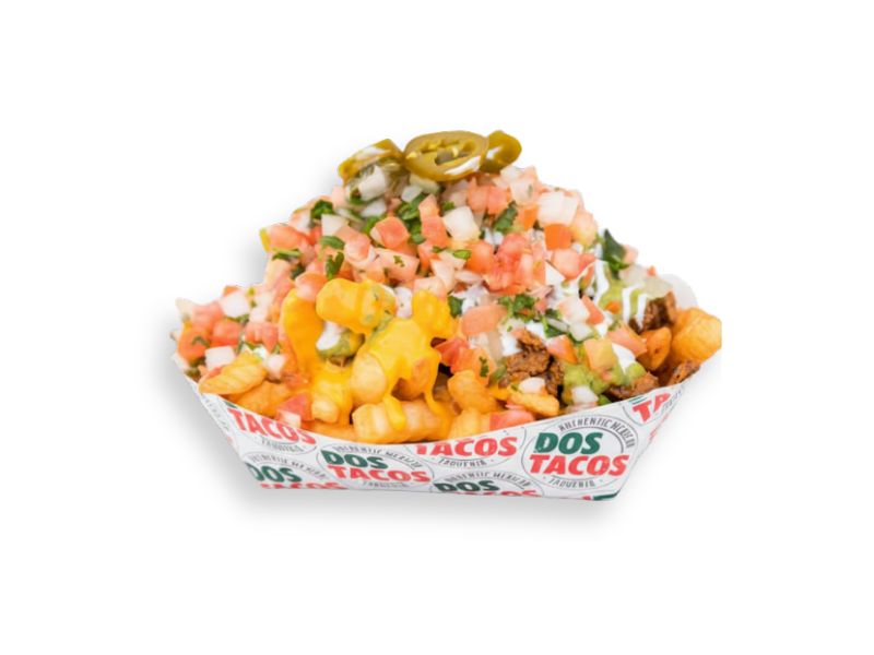 Close-up of fully loaded carne asada fries served in a paper tray, topped with melted nacho cheese, ground beef, guacamole, sour cream, and fresh pico de gallo and jalapeños.